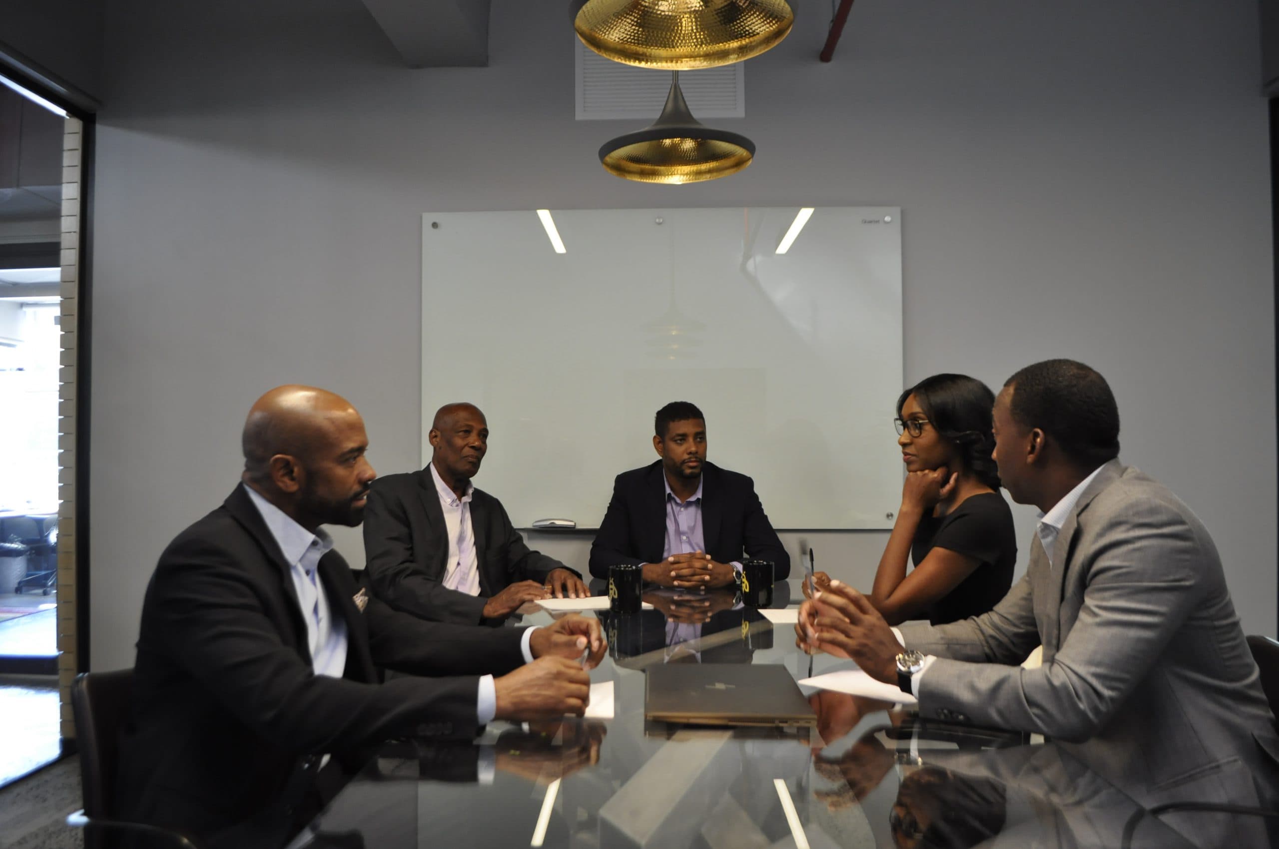 The Shields Industries team around a conference table